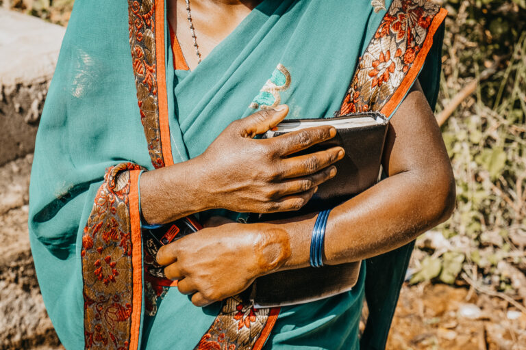 An Indian woman holding the Bible copy 768x512