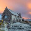 Stone church on a hill at sunset